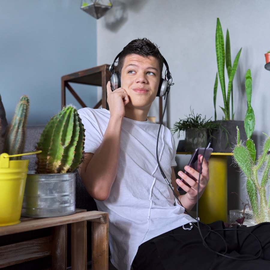 Jongen zit tussen planten